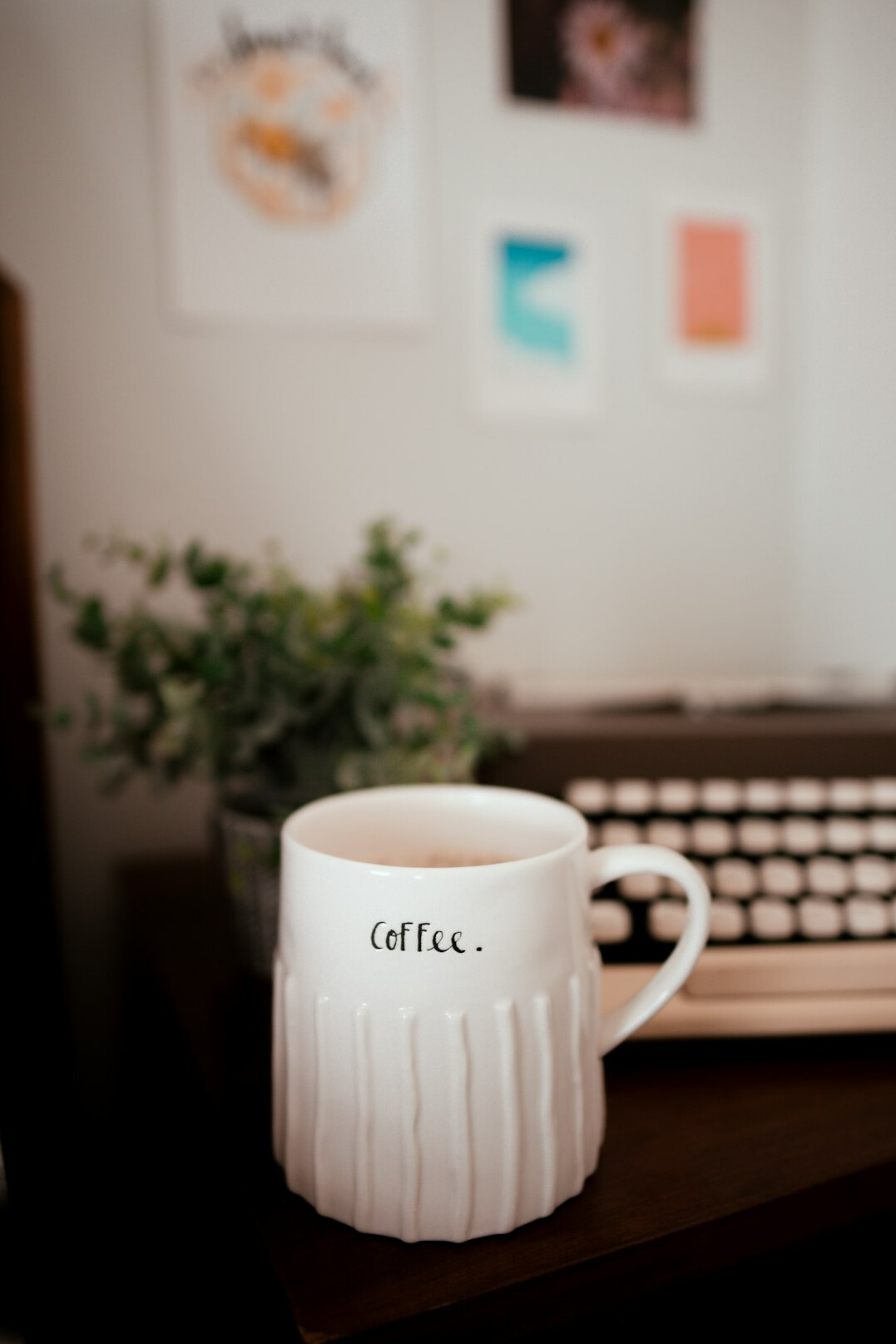 Vintage typewriter on a wooden desk with a cup of coffee