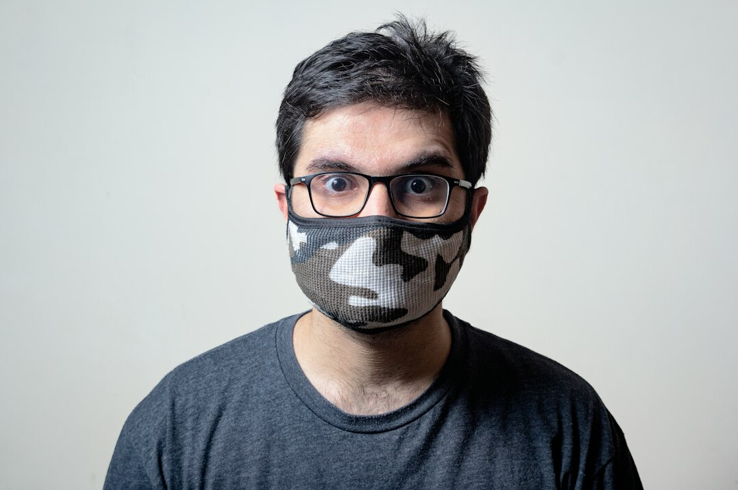 Studio portrait of a Hispanic man researcher in his 30s wearing glasses, neutral background
